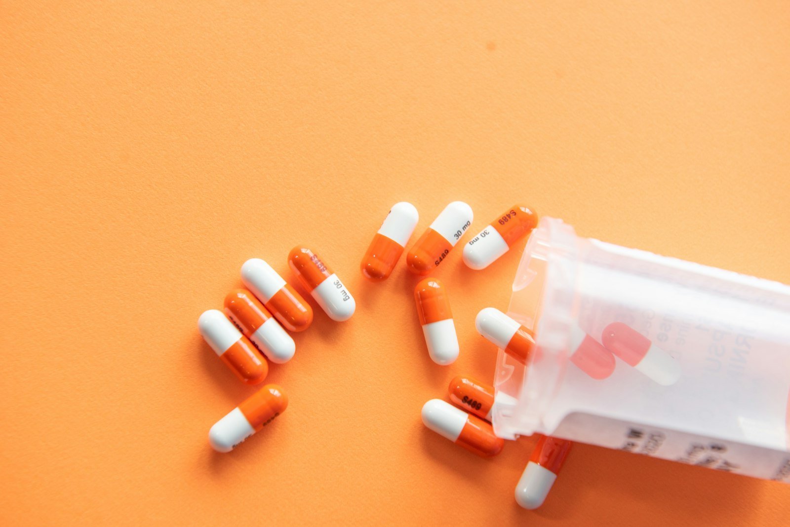 Capsules spilling from a medicine bottle